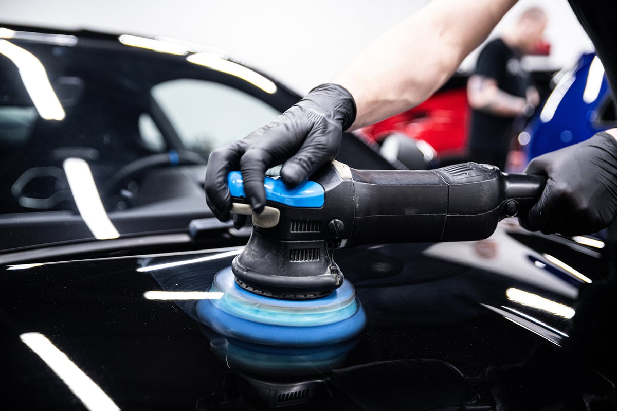 Detailer machine-polishing car paint to remove swirl marks